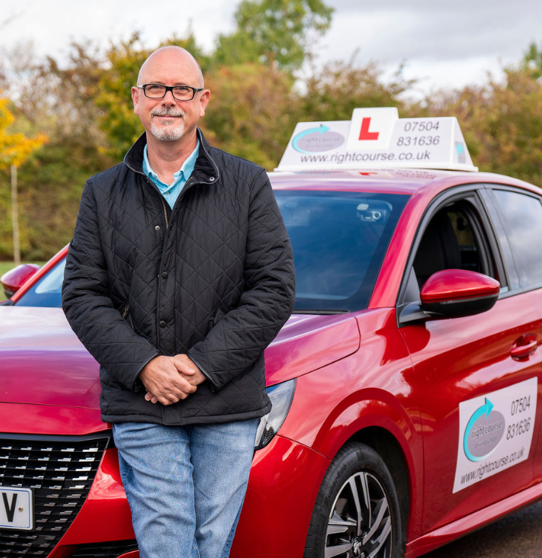 Jason Fleming sitting on his instructors car