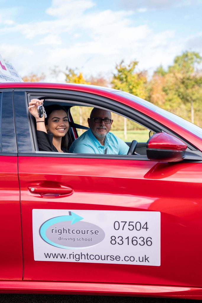 A pupil smiling because she has passed her driving test