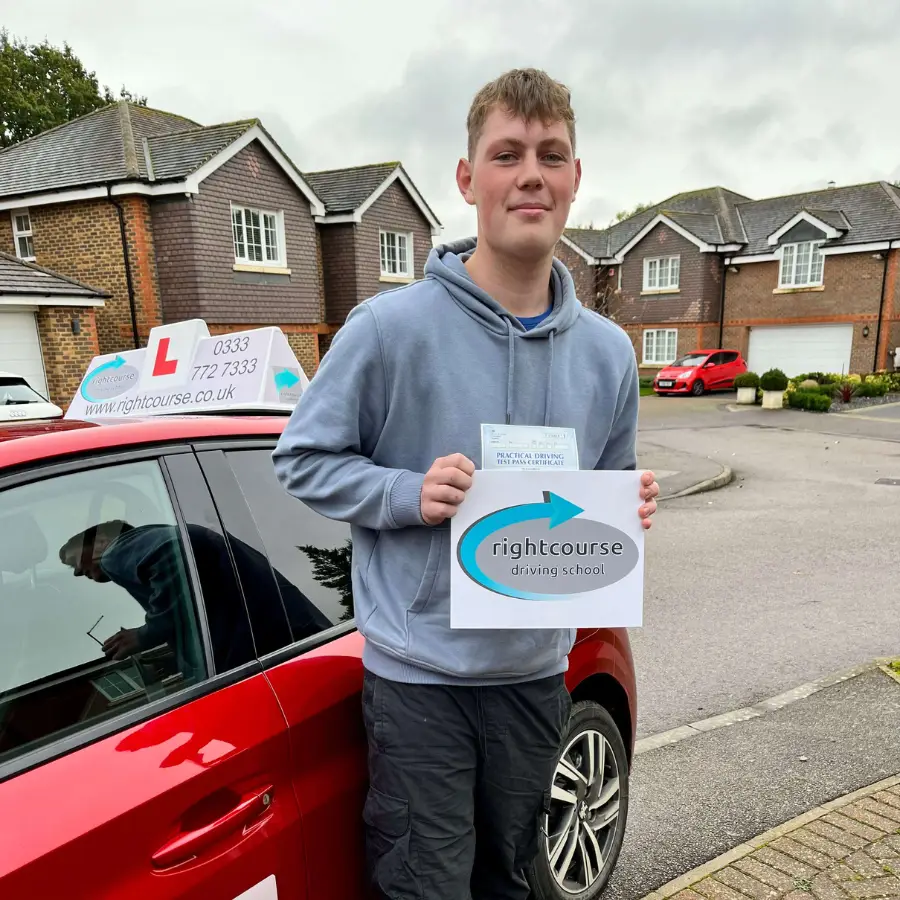 Right Course learner holding his driving test pass certificate